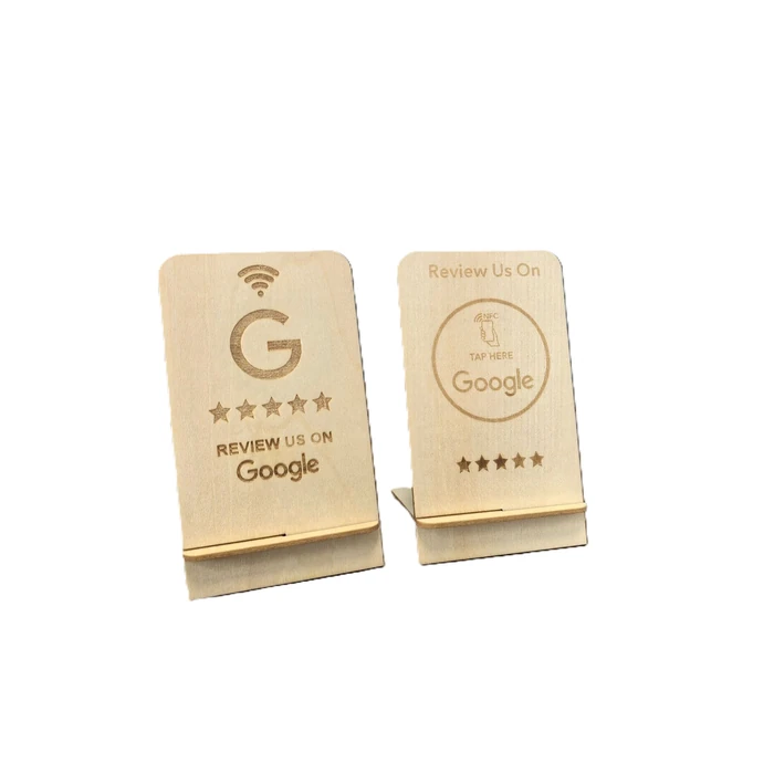 Two light-colored wooden review stands with different Google review artwork and tap prompts.